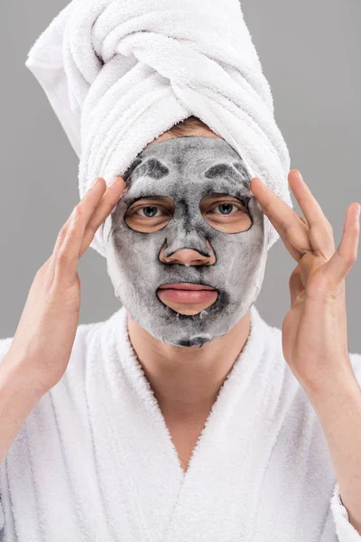 Front view of man in bathrobe with facial mask isolated on grey — Stock Photo