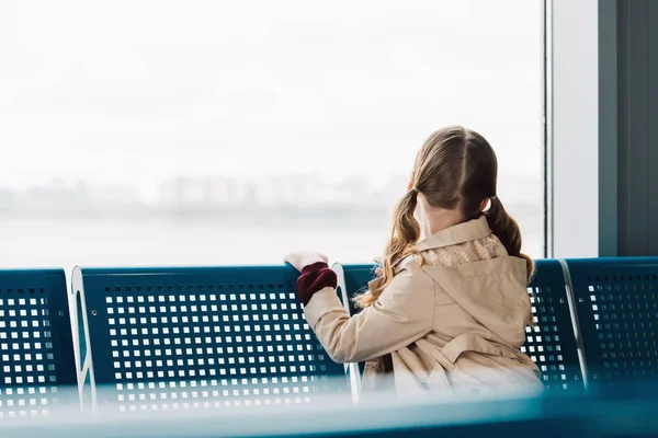 Back view of preteen kid looking at window in departure lounge — Stock Photo