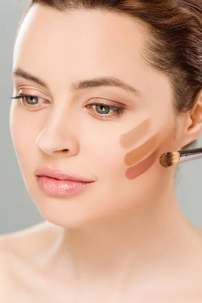 Attractive woman with eye shadow brown palette on face isolated on grey — Stock Photo