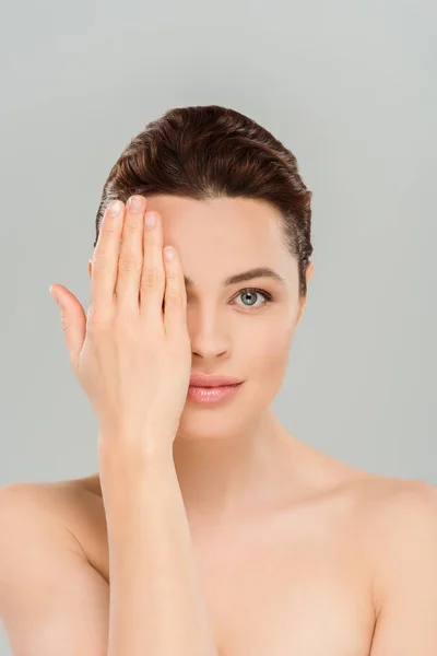 Naked and beautiful woman covering eye isolated on grey — Stock Photo