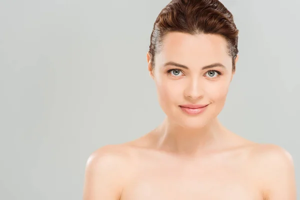 Nude and cheerful woman looking at camera isolated on grey — Stock Photo