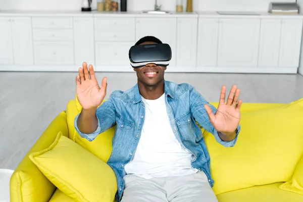 High angle view of happy african american man in vr headset sitting on couch — Stock Photo