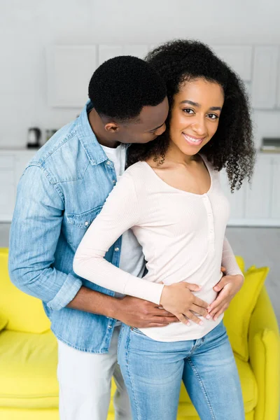 Happy african american couple cuddling to each other in bright room — Stock Photo