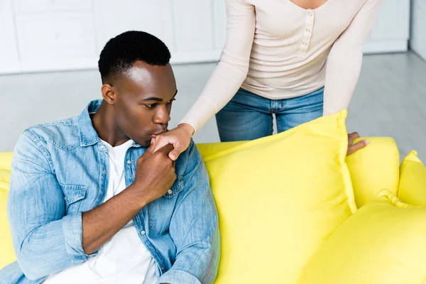 African american man kissing hand of girlfriend at home — Stock Photo