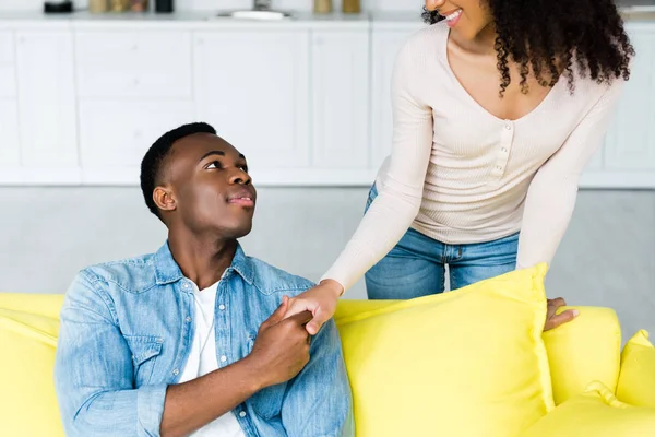 Happy african american couple holding hands and looking to each other — Stock Photo