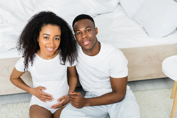 High angle view of happy african american couple sitting on floor — Stock Photo