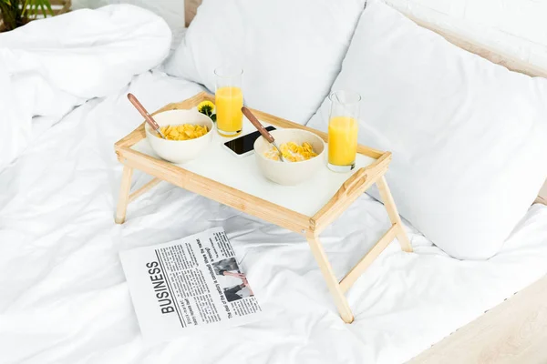 High angle view of table for breakfast on white bed in bedroom — Stock Photo