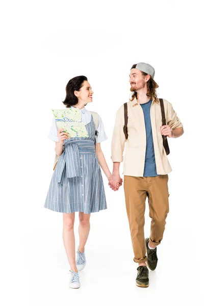 Full length view of girl holding map and young man holding hands and smiling isolated on white — Stock Photo