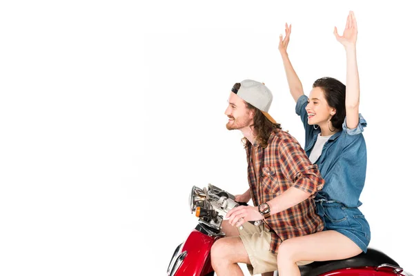 Vue latérale de la fille avec les mains dans l'air et jeune homme assis sur scooter rouge isolé sur blanc — Photo de stock