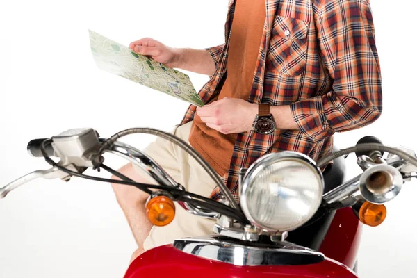 Cropped view of man holding map in hands, standing near red scooter isolated on white — Stock Photo