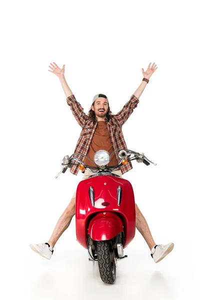 Vue pleine longueur du jeune homme heureux avec les mains sur l'air, assis sur scooter rouge isolé sur blanc — Photo de stock