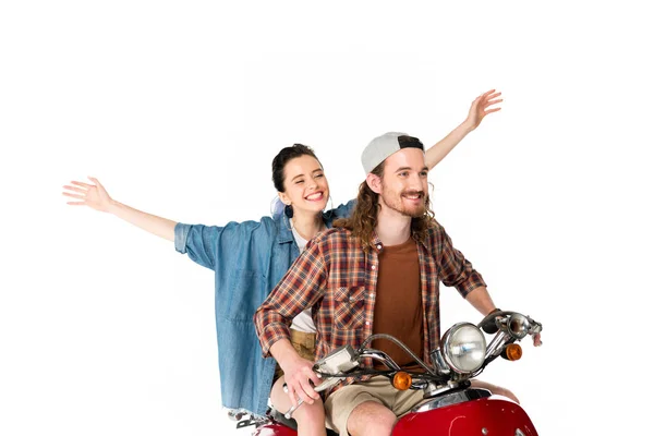 Couple of young tourists riding on red scooter holding hands in air isolated on white — Stock Photo