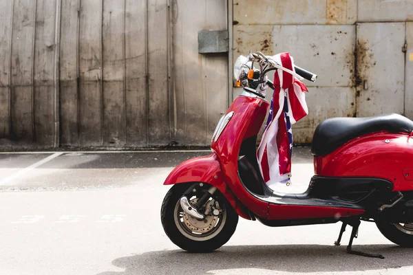 Red scooter with American flag on handle — Stock Photo