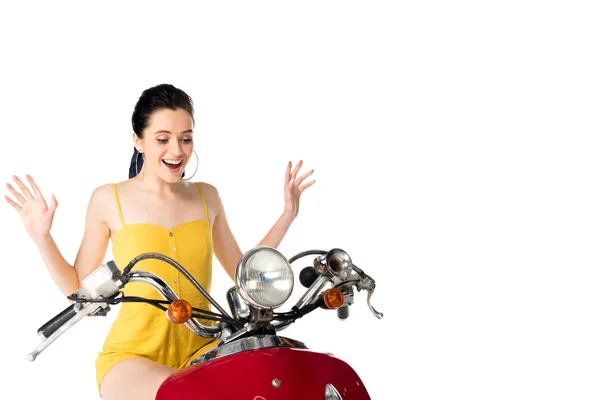 Bella e sorpresa ragazza seduta su scooter rosso isolato su bianco — Foto stock