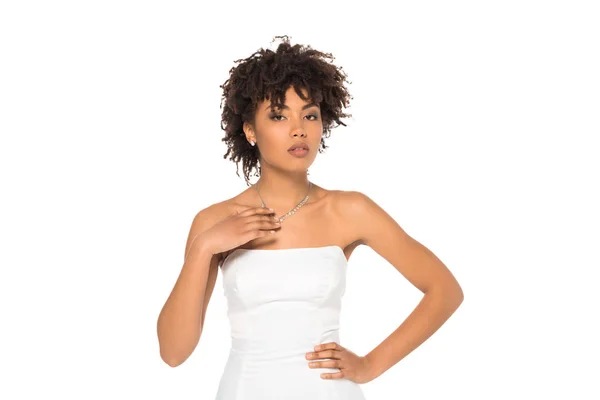 Attractive african american woman standing in wedding dress with hand on hip isolated on white — Stock Photo