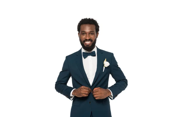 Cheerful bearded african american man touching suit isolated on white — Stock Photo