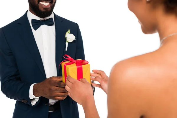 Cropped view of happy african american bridegroom giving present to curly bride isolated on white — Stock Photo