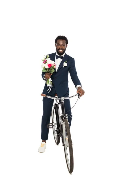 Felice uomo africano americano che tiene bouquet e bicicletta isolati su bianco — Foto stock