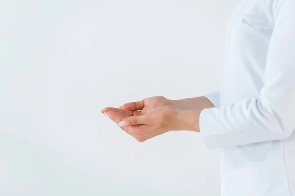 Cropped view of woman standing with cupped hands isolated on white — Stock Photo