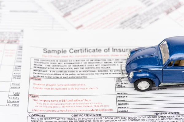 Selective focus of insurance documents and blue toy car — Stock Photo