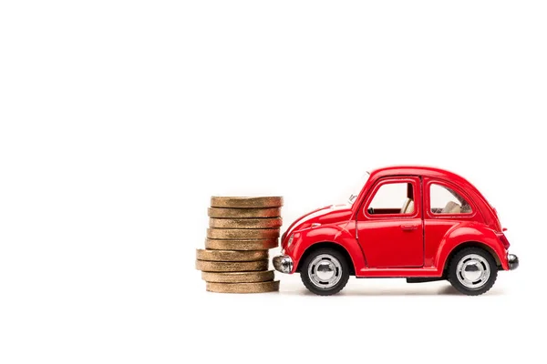 Red toy car and golden coins on white — Stock Photo