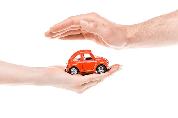 Cropped view of woman and man with red toy car isolated on white — Stock Photo