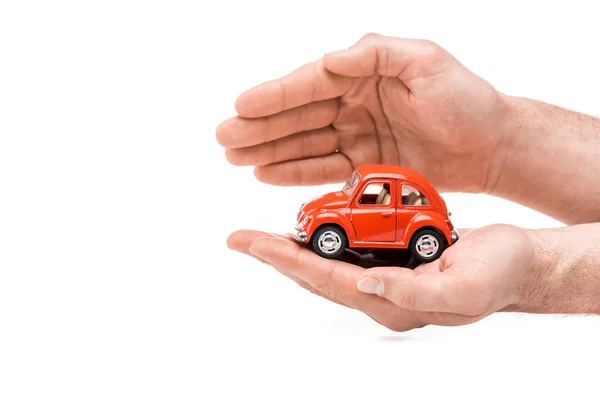 Cropped view of man holding red toy car isolated on white — Stock Photo