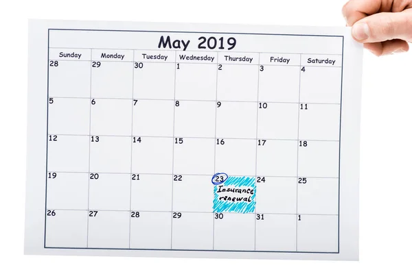 Cropped view of man holding calendar with marked date — Stock Photo