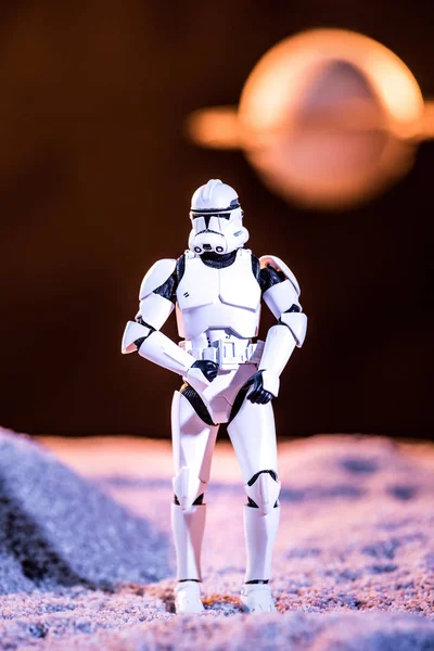 White imperial stormtrooper on cosmic planet on dark background — Photo de stock