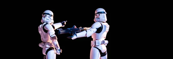 Toy white imperial stormtroopers with gun isolated on black — Stockfoto