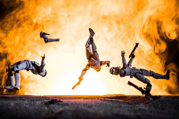 White plastic Imperial Stormtrooper levitating in space in front of explosion — Stock Photo