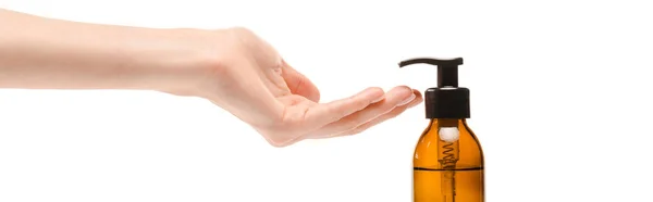 Panoramic shot of woman with cupped hand near dispenser bottle with isolated on white — Stock Photo