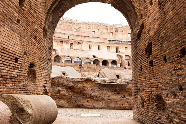 ROMA, ITALIA - 28 DE JUNIO DE 2019: turistas en edificio antiguo con paredes de ladrillo - foto de stock