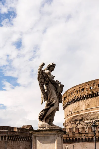 ROME, ITALY - JUNE 28, 2019: ancient roman statue near old building in sunny day under blue sky — Stock Photo