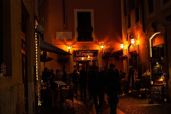 ROME, ITALY - JUNE 28, 2019: crowd of people on dark street at night — Stock Photo
