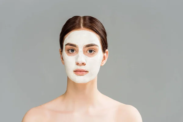 Jeune femme nue avec masque en argile sur le visage isolé sur gris — Photo de stock
