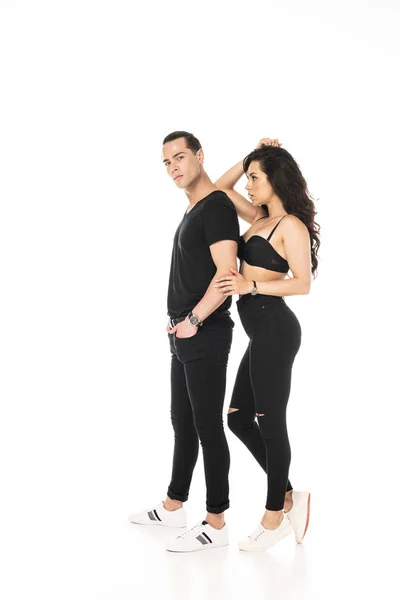 Full length view of man with hand in pocket and sexy girl in black bra isolated on white — Stock Photo