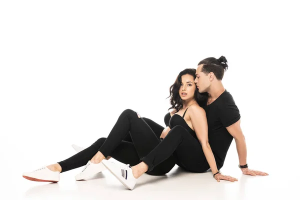Sexy young couple sitting on floor on white — Stock Photo