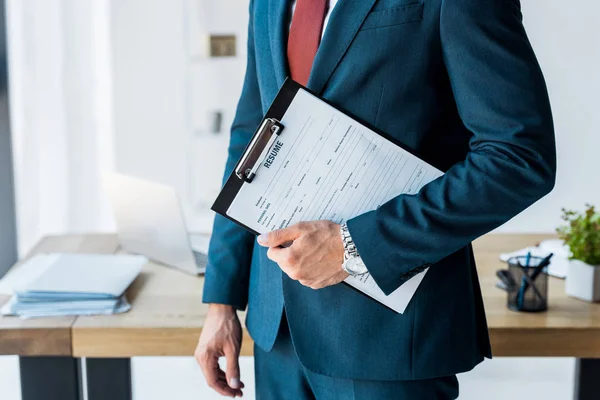 Cropped view of recruiter standing and holding clipboard with resume letters — Stock Photo
