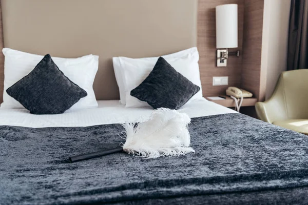 White duster on bed with pillows in hotel room — Stock Photo