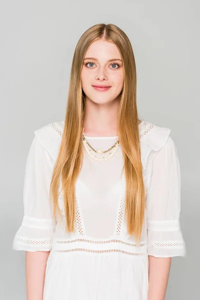 Beautiful girl in white dress looking at camera isolated on grey — Stock Photo