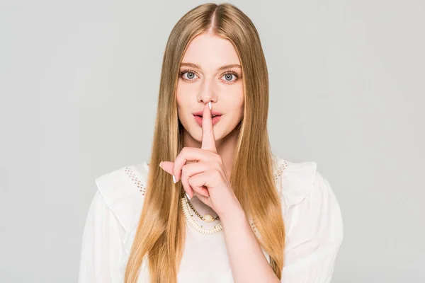 Beautiful girl doing silence gesture isolated on grey — Stock Photo