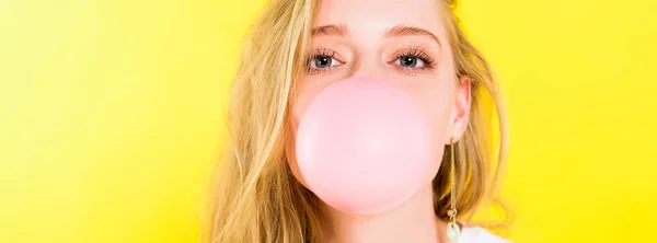 Panoramic shot of beautiful girl blowing bubble gum Isolated On yellow — Stock Photo