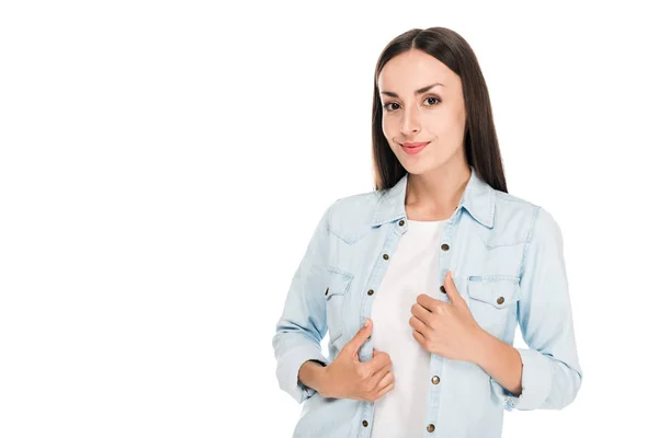 Smiling brunette woman with hands on denim jacket isolated on white — Stock Photo