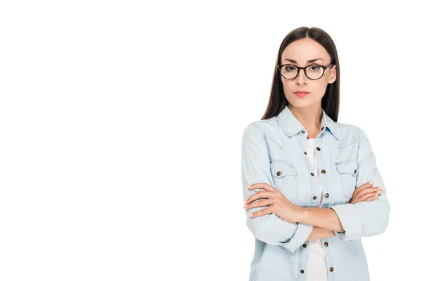 Brunette girl in glasses in denim jacket with crossed arms isolated on white — Stock Photo