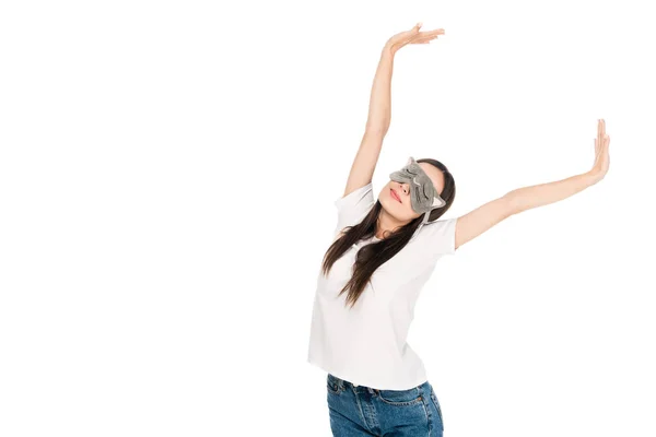 Brunette young woman in cat sleeping eye mask outstretching herself isolated on white — Stock Photo