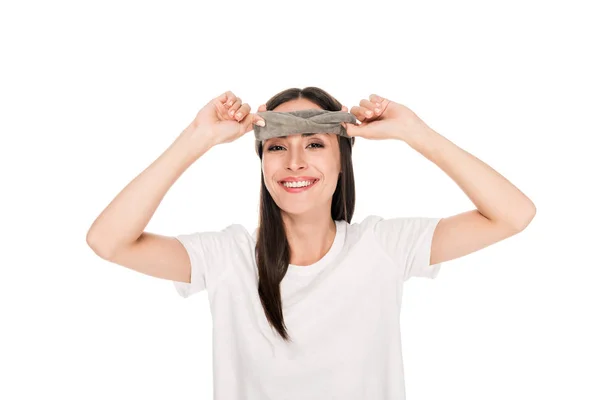 Happy brunette young woman in cat sleeping eye mask isolated on white — Stock Photo