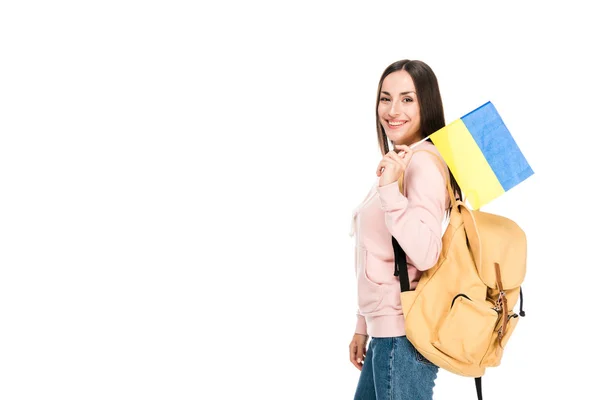 Side view of smiling student with backpack holding Ukrainian flag isolated on white — Stock Photo