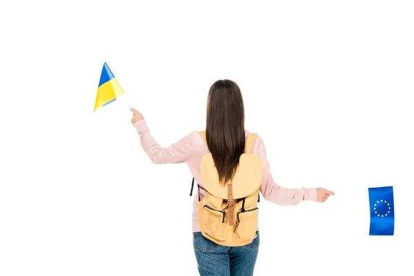 Back view of student with backpack holding Ukrainian and European flags isolated on white — Stock Photo