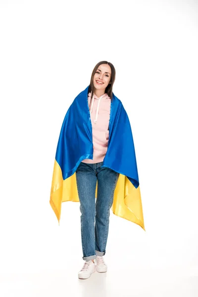 Full length view of happy young girl in satin flag of Ukraine isolated on white — Stock Photo